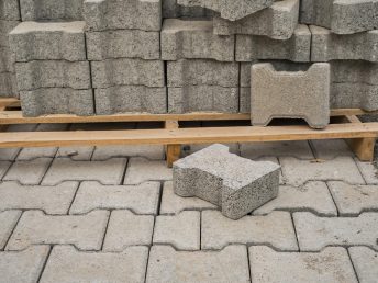 paving-slabs-stacked-pallet-road-repair-process-closeup-selective-focus-tiles-seasonal-reconstruction-pavement-walking-paths-parks